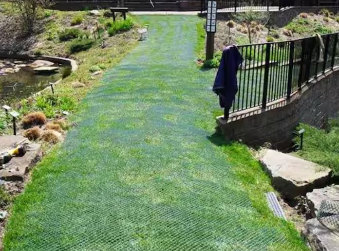 Ground reinforcement mesh rolled out on turf