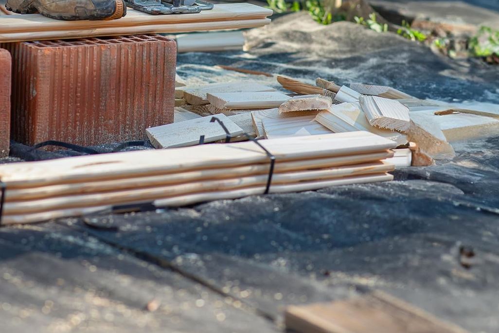 Installing non-woven filter fabric beneath gravel